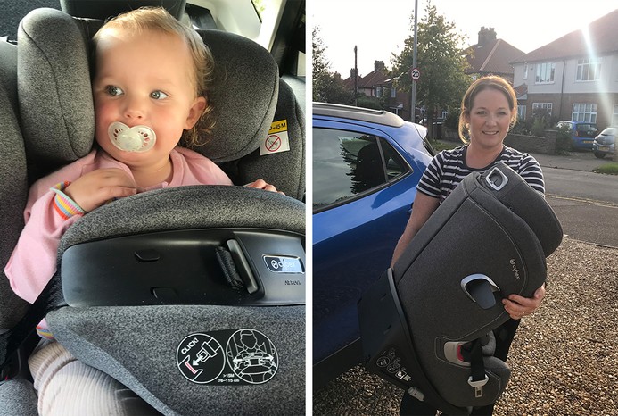 Baby in Cybex Anoris T car seat and reviewer holding seat