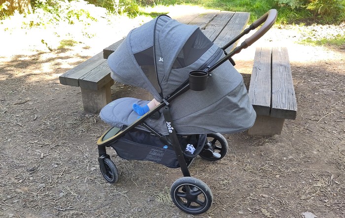 Baby in Joie Mytrax Pro pushchair in wooded area