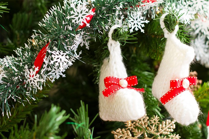 white baby bootees on a Christmas tree