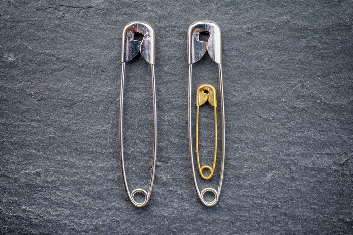 2 safety pins side by side with a little safety pin inside one of them