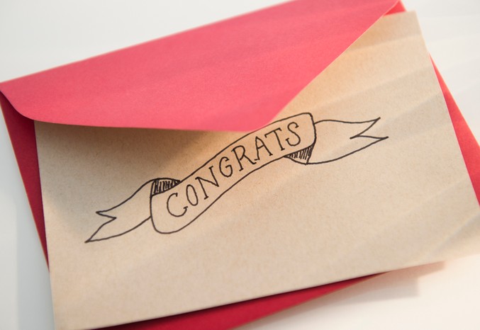 Pink envelope and white congratulations card