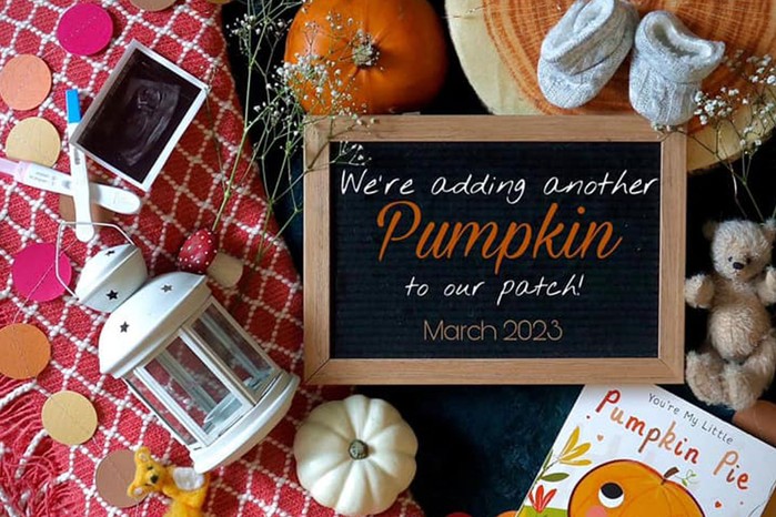 halloween themed pregnancy announcement with chalkboard and pumpkins