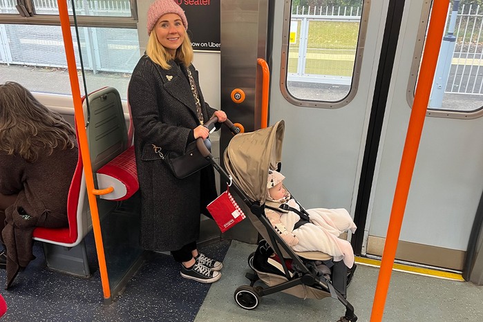 Reviewer with Joolz Aer+ stroller on train