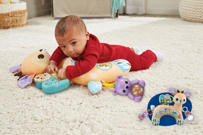 A baby playing with the 4-in-1 Tummy Time Fawn set